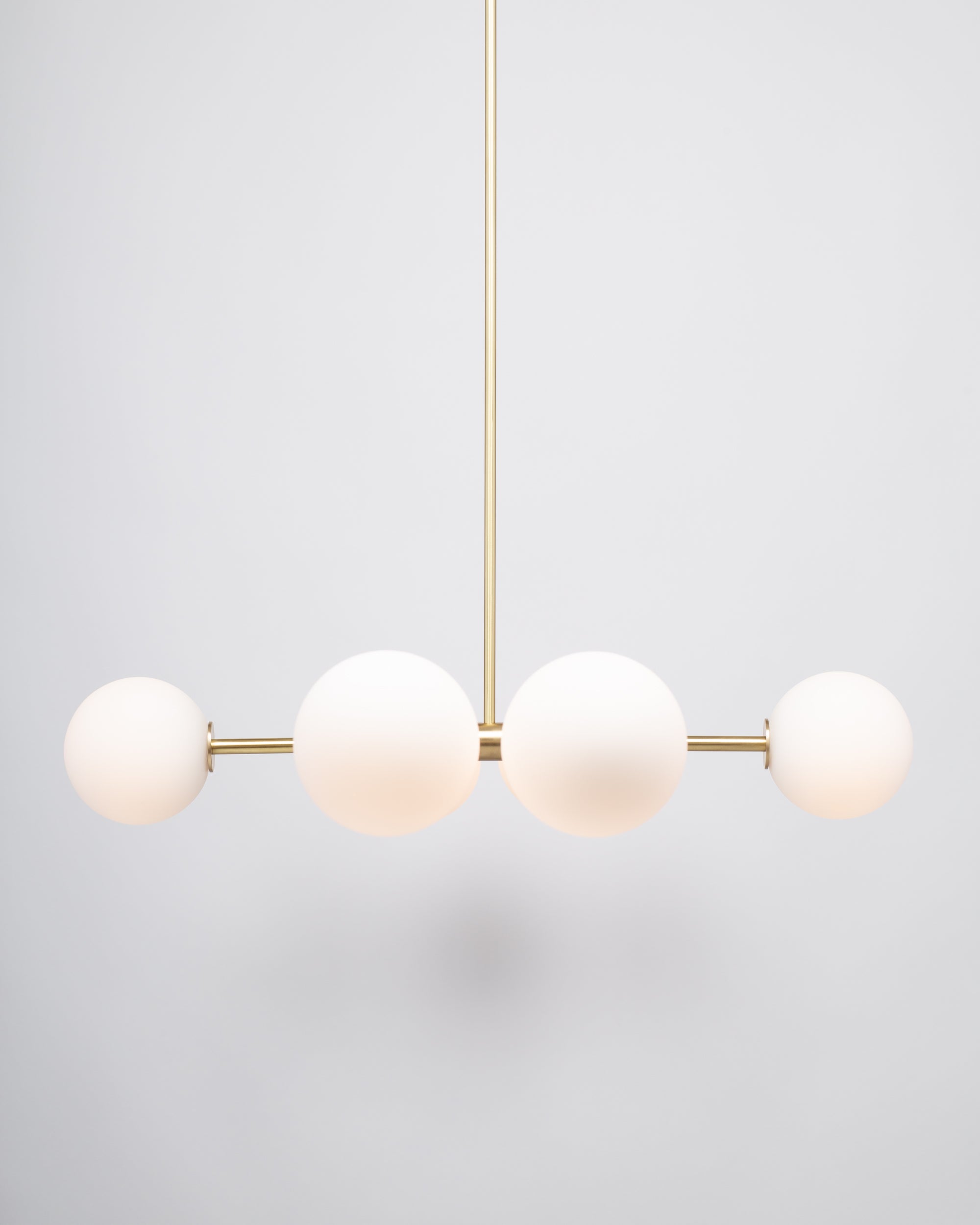 Six Matte Sphere Articulating Satin Brass Pendant